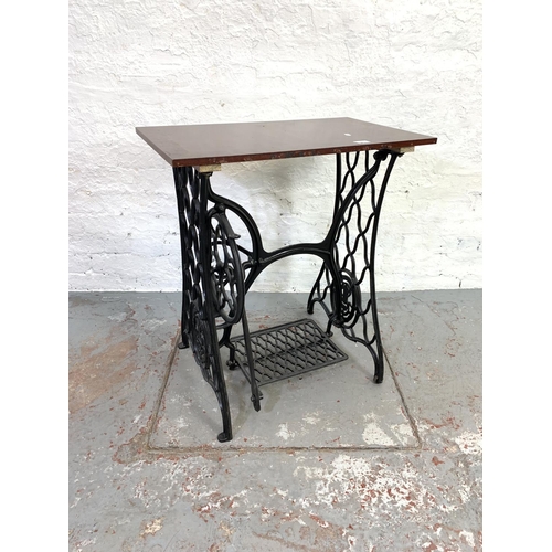 682 - A Singer treadle sewing machine cast iron base with mahogany table top