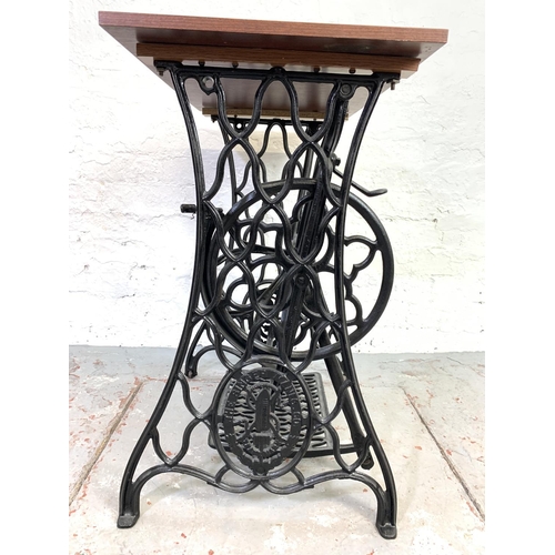 682 - A Singer treadle sewing machine cast iron base with mahogany table top