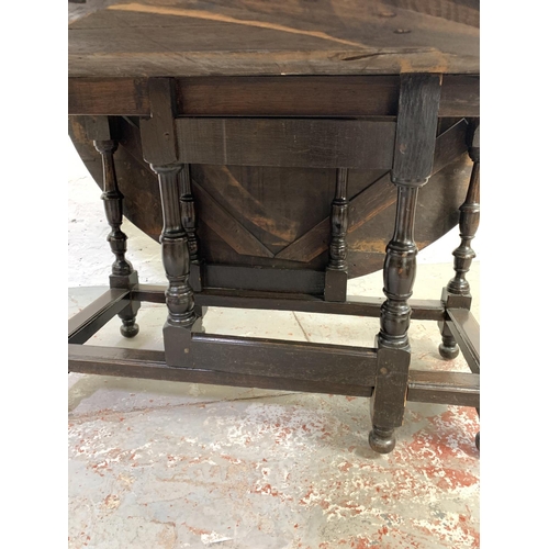 688 - A 19th century oak drop leaf gate leg dining table