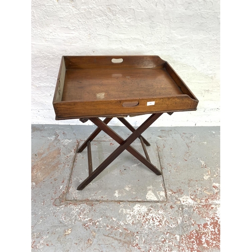 691 - A 19th century mahogany campaign butlers tray on stand