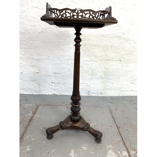 693 - A Victorian mahogany bible stand with carved fretwork back - approx. 87cm high x 37cm wide x 27cm de... 