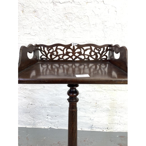 693 - A Victorian mahogany bible stand with carved fretwork back - approx. 87cm high x 37cm wide x 27cm de... 