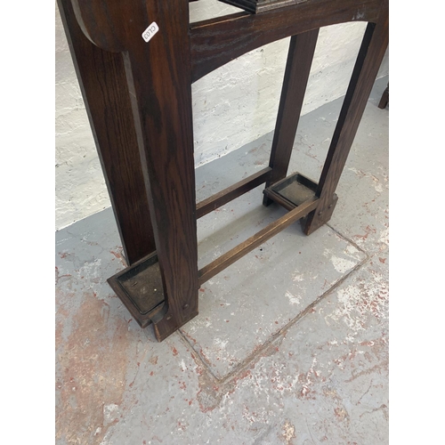 695 - An Art Deco oak hall stand with centre bevelled mirror, six coat hooks and original drip trays - app... 