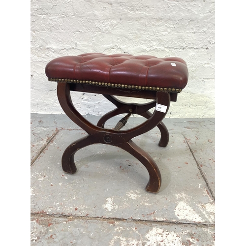 699 - A red leather and mahogany Chesterfield footstool with 'X' frame base - approx. 44cm high x 48cm wid... 