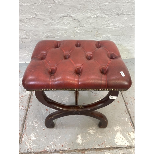 699 - A red leather and mahogany Chesterfield footstool with 'X' frame base - approx. 44cm high x 48cm wid... 