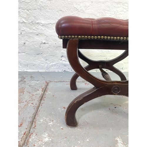 699 - A red leather and mahogany Chesterfield footstool with 'X' frame base - approx. 44cm high x 48cm wid... 