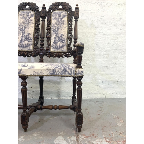 701 - A late Victorian heavily carved oak and upholstered two seater bench - approx. 110cm high x 72cm wid... 