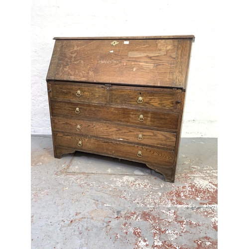 707 - A 19th century oak bureau with two short drawers, three long drawers and fall front - approx. 108cm ... 