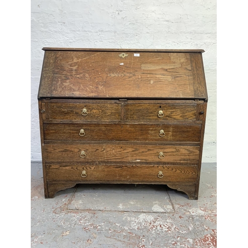 707 - A 19th century oak bureau with two short drawers, three long drawers and fall front - approx. 108cm ... 