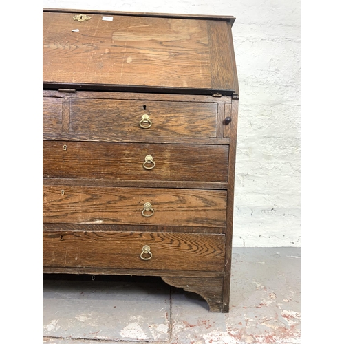 707 - A 19th century oak bureau with two short drawers, three long drawers and fall front - approx. 108cm ... 