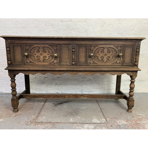 710 - A 19th century Gothic revival oak sideboard with two large drawers and one lower stretcher - approx.... 