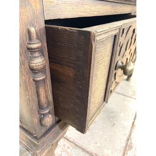 710 - A 19th century Gothic revival oak sideboard with two large drawers and one lower stretcher - approx.... 