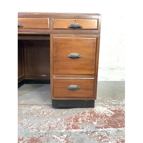 712 - A 1930s H. Baldock & Son of Liverpool mahogany pedestal desk with seven drawers and half moon handle... 