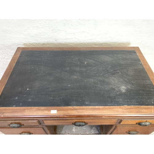 712 - A 1930s H. Baldock & Son of Liverpool mahogany pedestal desk with seven drawers and half moon handle... 