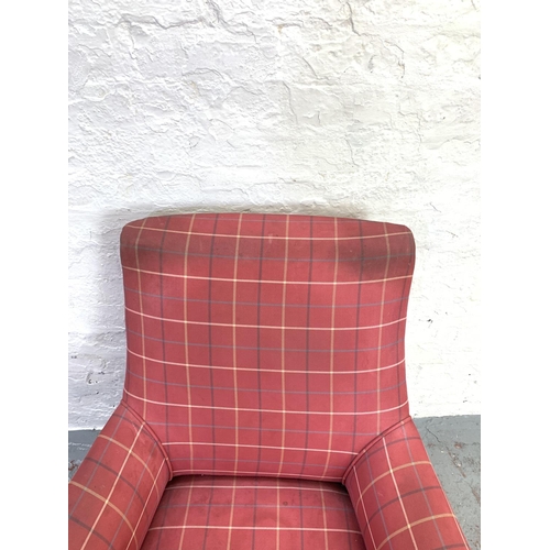 713 - A Victorian red upholstered library armchair on ebonized supports