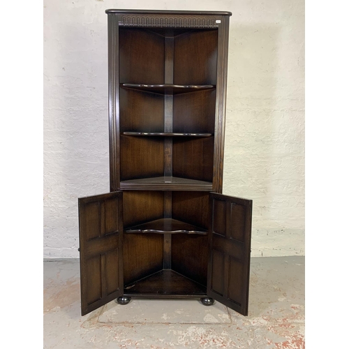 762 - An oak free standing corner cabinet with two lower doors - approx. 167cm high