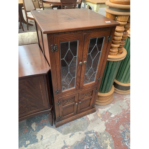 720 - An oak media cabinet with two lower doors and two upper glazed doors - approx. 114cm high x 54cm wid... 