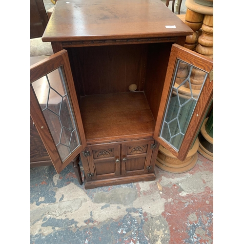 720 - An oak media cabinet with two lower doors and two upper glazed doors - approx. 114cm high x 54cm wid... 