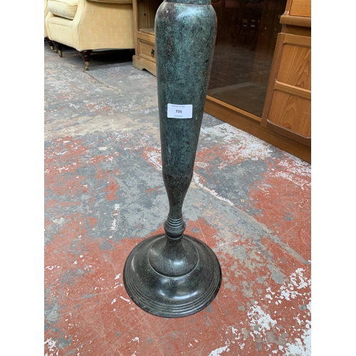 735 - An aged bronze effect floor standing three branch candelabra - approx. 97cm high x 46cm wide