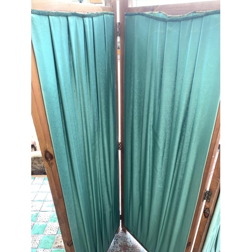 743 - A pine and green upholstered three section folding dressing screen - approx. 168cm high x 172cm exte... 