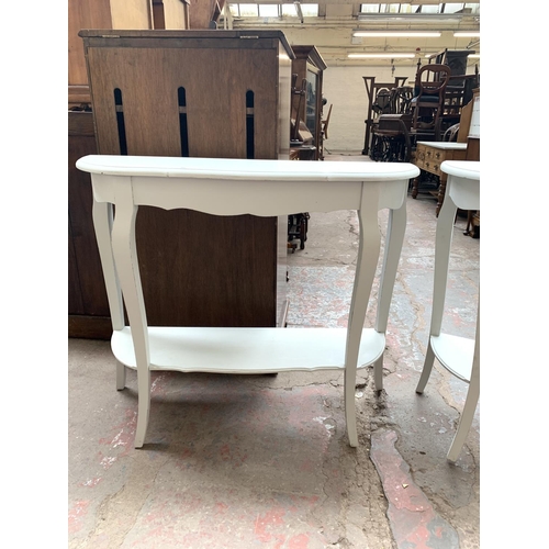 756 - Two modern white painted serpentine two tier console tables - approx. 78cm high x 94cm wide x 32cm d... 