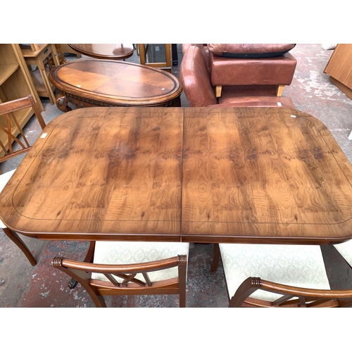 767 - A yew wood extending twin pedestal dining table and six matching chairs - approx. 76cm high x 152cm ... 