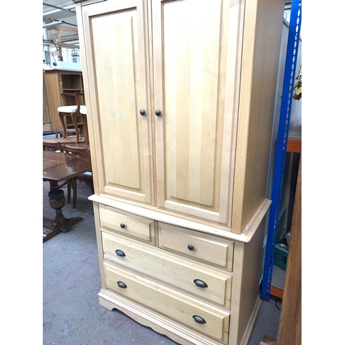 772 - A Ragazzi beech bedroom cabinet with two upper doors, two short drovers over two long drawers - appr... 