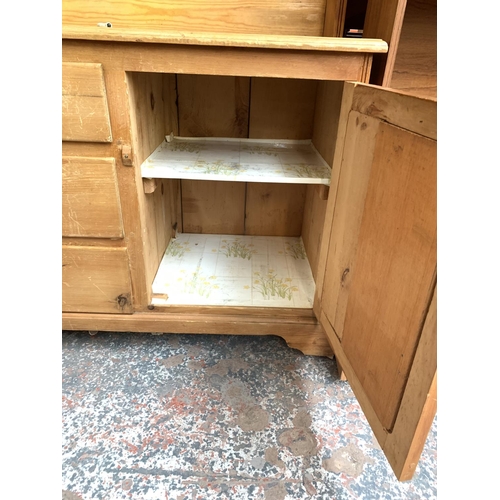 775 - A modern pine dresser with two doors, three central drawers and upper plate rate - approx. 188cm hig... 