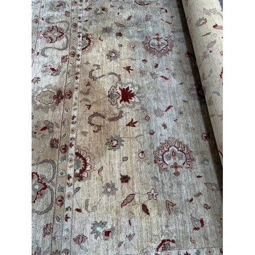 787 - A large oriental cream and red 100% wool rug - approx. 357cm x 280cm