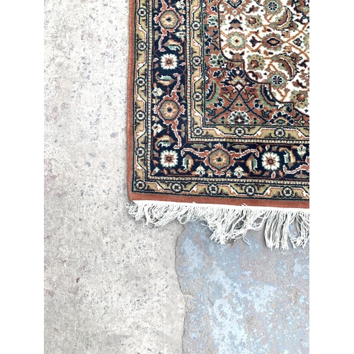 790 - An Obeetee hand knotted oriental rug - approx. 159cm x 91cm