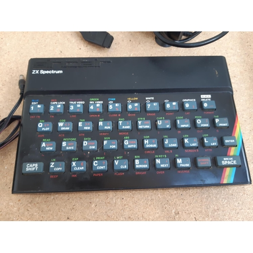 1061 - A box containing Sinclair ZX Spectrum, ZX power supply, Spectravideo™ joystick, Datel Electronics jo... 