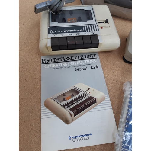 1064 - A box containing Commodore 64 with user manual, Commodore 1530 C2N Datassette with instruction manua... 