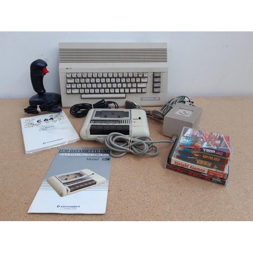 1065 - A box containing Commodore 64 C64C with user manual, Commodore 1530 C2N Datasette with instruction m... 