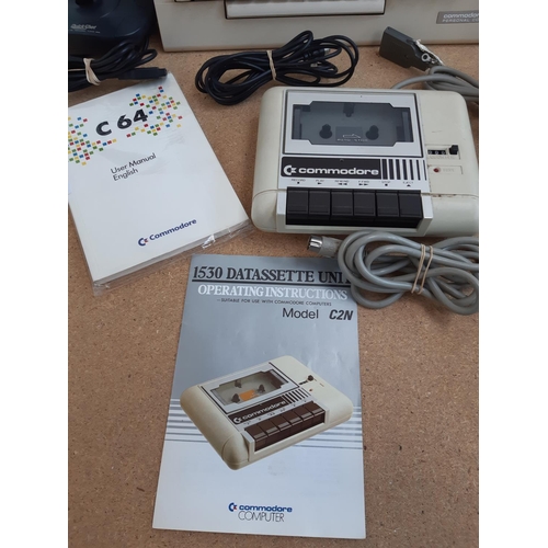 1065 - A box containing Commodore 64 C64C with user manual, Commodore 1530 C2N Datasette with instruction m... 