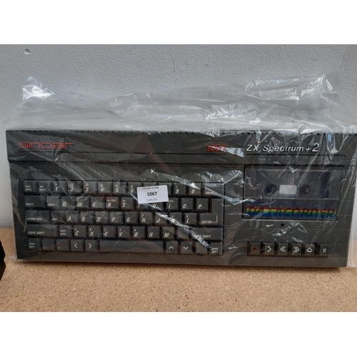 1067 - A box containing grey Sinclair ZX Spectrum 128K +2, Sinclair SJS-1 joystick, power supply, instructi... 