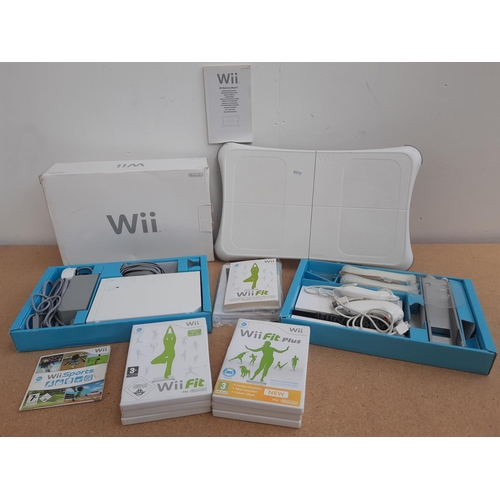 1069 - A boxed Nintendo Wii console with balance board, two controllers, two nunchuks, power supply and sev... 