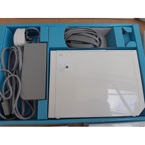 1069 - A boxed Nintendo Wii console with balance board, two controllers, two nunchuks, power supply and sev... 