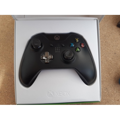 1070 - A box containing Xbox one console, two Xbox One wireless controllers (one boxed), two power supplies... 