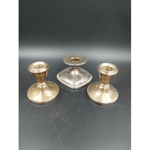 258 - Three dwarf candlesticks, one white metal with weighted base and a pair of hallmarked Birmingham sil... 