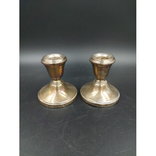 258 - Three dwarf candlesticks, one white metal with weighted base and a pair of hallmarked Birmingham sil... 