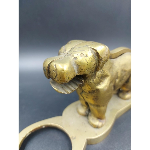 335 - A vintage novelty brass nut cracker in the form of a dog