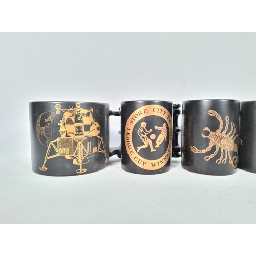 426 - Eight various Portmeirion Pottery black and gold mugs to include Stoke City F.C 1972 League Cup Winn... 