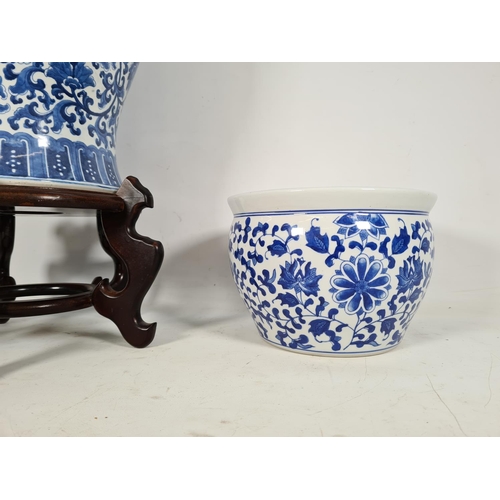 438 - Two Oriental blue & white ceramic items, one jardinere with wooden stand and one 43cm ginger jar wit... 