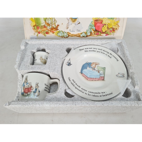 460 - A boxed Wedgwood Peter Rabbit four piece nursery set comprising plate, porringer, mug and egg cup