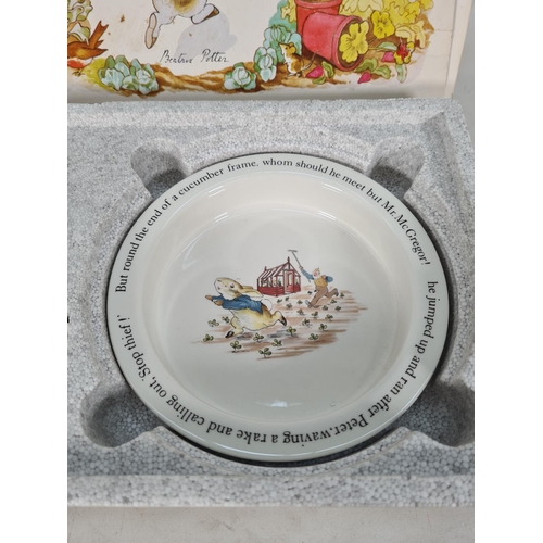 460 - A boxed Wedgwood Peter Rabbit four piece nursery set comprising plate, porringer, mug and egg cup