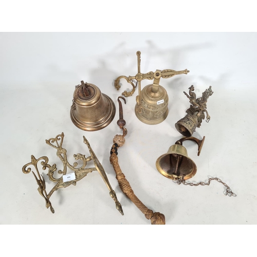 490 - Four vintage brass bells and one brass bracket