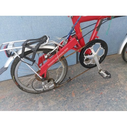 1200 - A red Riese and Muller Birdie folding bicycle with quick release wheels, Tektro brakes, rear carrier... 