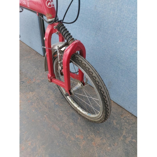 1200 - A red Riese and Muller Birdie folding bicycle with quick release wheels, Tektro brakes, rear carrier... 