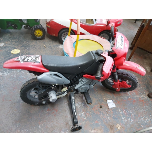 1203 - Two items, one black and red Powersports ride-on electric motocross bike and one multi-coloured chil... 