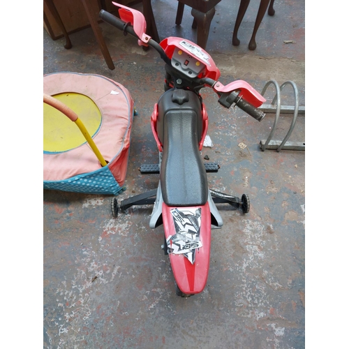 1203 - Two items, one black and red Powersports ride-on electric motocross bike and one multi-coloured chil... 